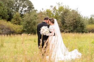 Wedding Couple stands in field