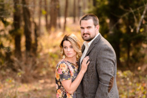 middle georgia engagement session in field couple holding each other