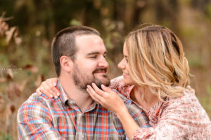 georgia engagement session couple in field kissing