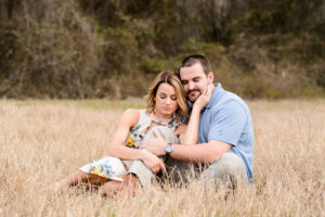couples engagement session in field at sunset blue shirt