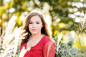 brown haired girl standing and looking during senior portrait session middle georgia