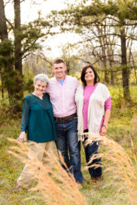 family standing in field in middle georgia for family photography session, sunset pictures