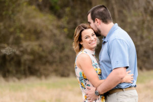 middle georgia engagement session at tryphenas garden wedding venue couple in field laughing