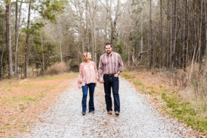 couple walking on gravel road engagement session middle georgia