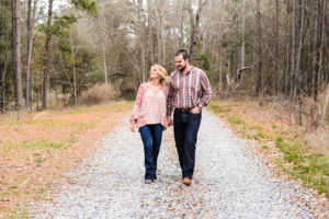 couple walking and laughing during engagement session in middle georgia