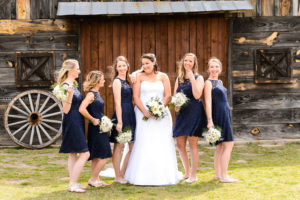 middle georgia wedding, bridal portrait, bridal party standing in front of barn laughing