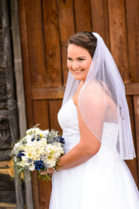 middle georgia wedding, bridal portrait, bride standing holding bouquet in front of barn